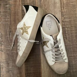 Women’s white star sneakers by Shu Shop